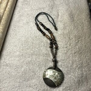 Wood beaded necklace with mother of pearl looking pendant. Overall necklace 24”